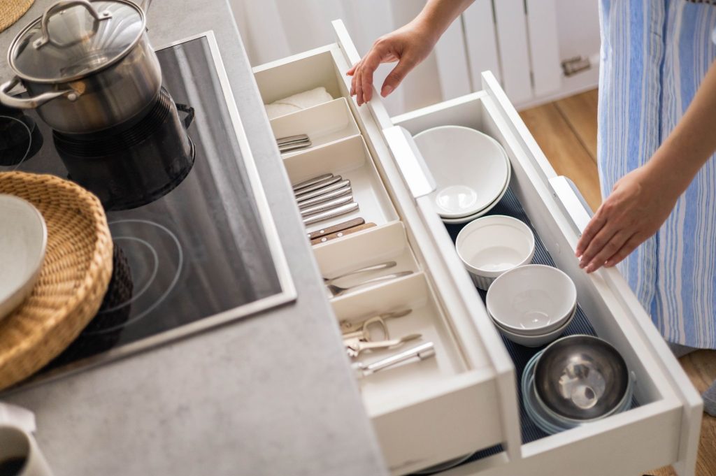 Organized kitchen drawer with bowls and silverware