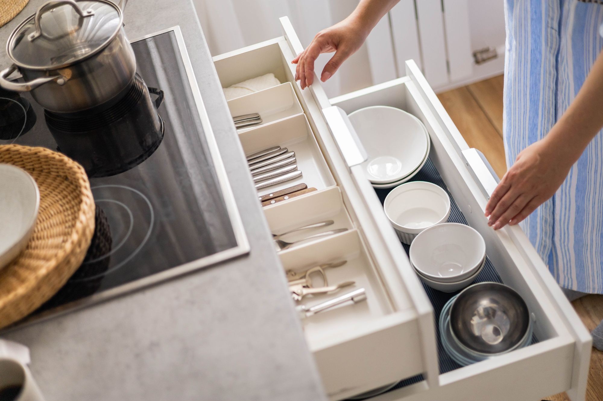 Organized kitchen drawer with bowls and silverware